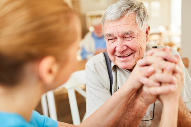 Elderly man thanking a nurse