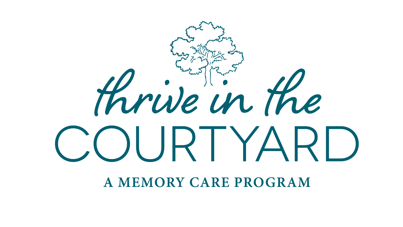 Logo for "Thrive in the Courtyard - A Memory Care Program" with teal text. The logo features a stylized tree above the words, with "thrive in the" in a cursive font and "COURTYARD" and "A MEMORY CARE PROGRAM" in bold, uppercase font, reflecting its dedication to skilled nursing and compassionate care.