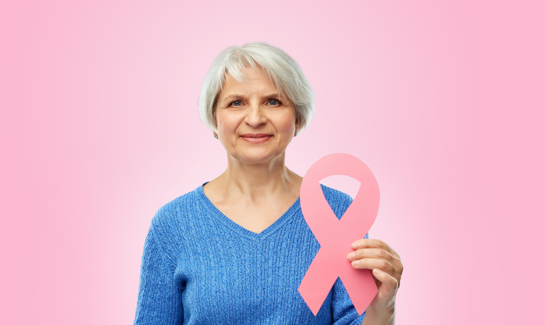senior woman holding breast cancer awareness ribbon