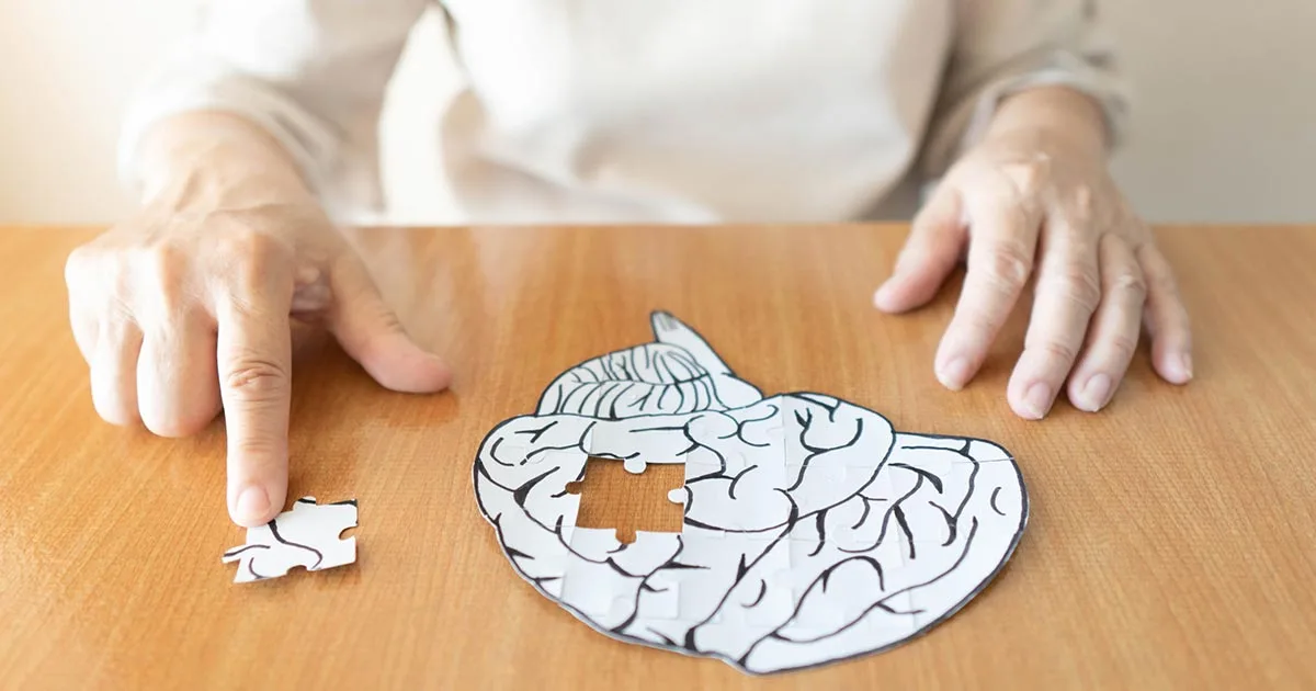Senior playing with a brain puzzle