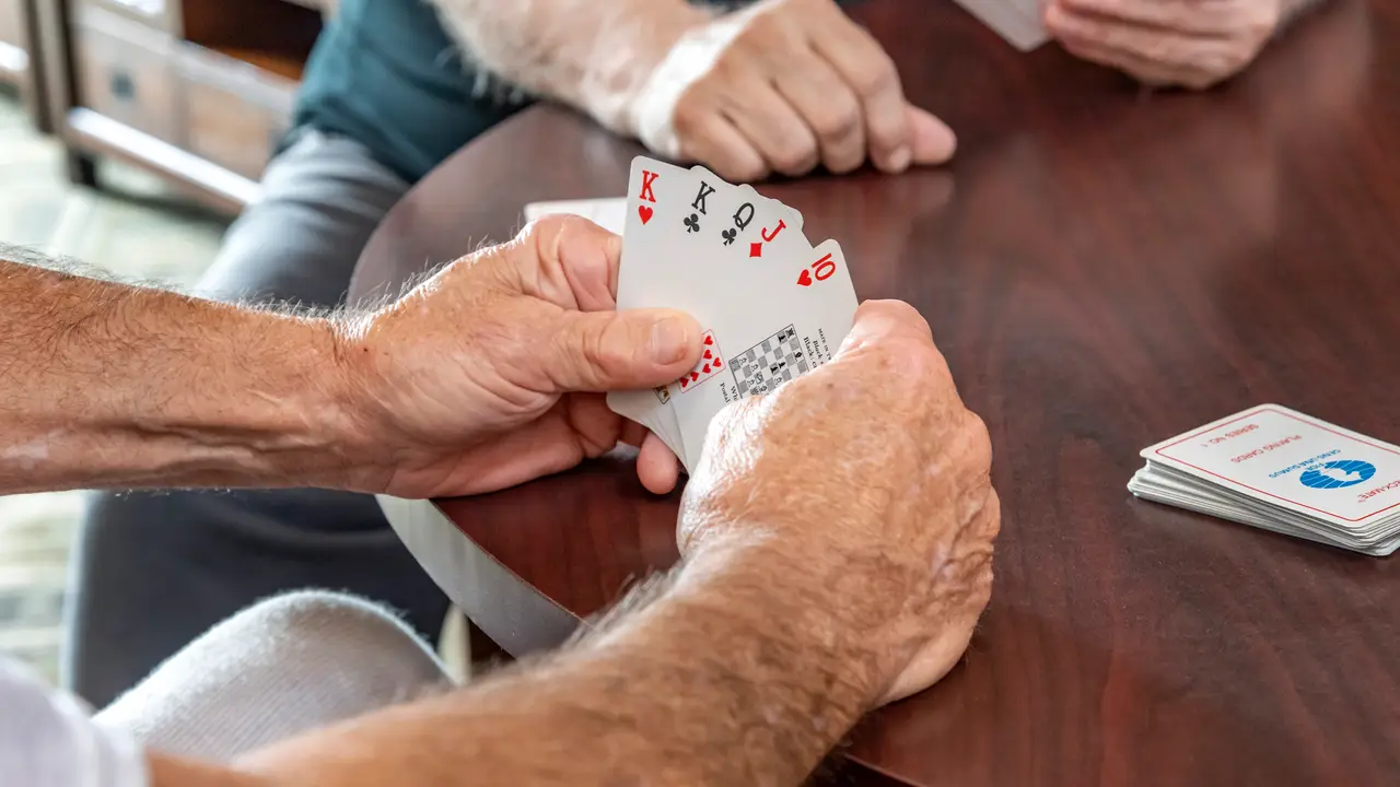 Monterey Park hands holding a hand of cards
