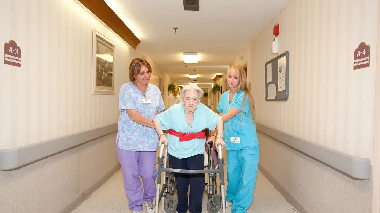 Carlinville residents walking down hall with patient