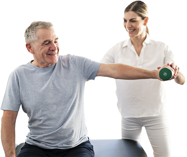 Senior male resident exercising with physical therapist