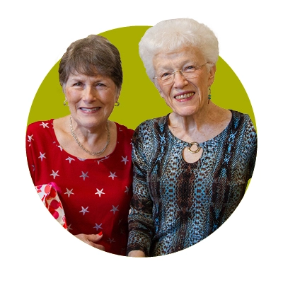 Two senior female residents posing for a photo