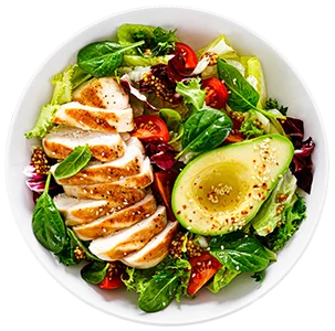 Sliced chicken breasts on a bed of salad
