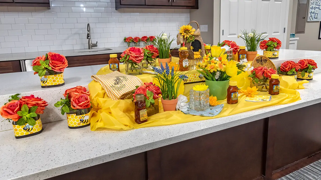 Honey event, honey and flowers on a granite counter