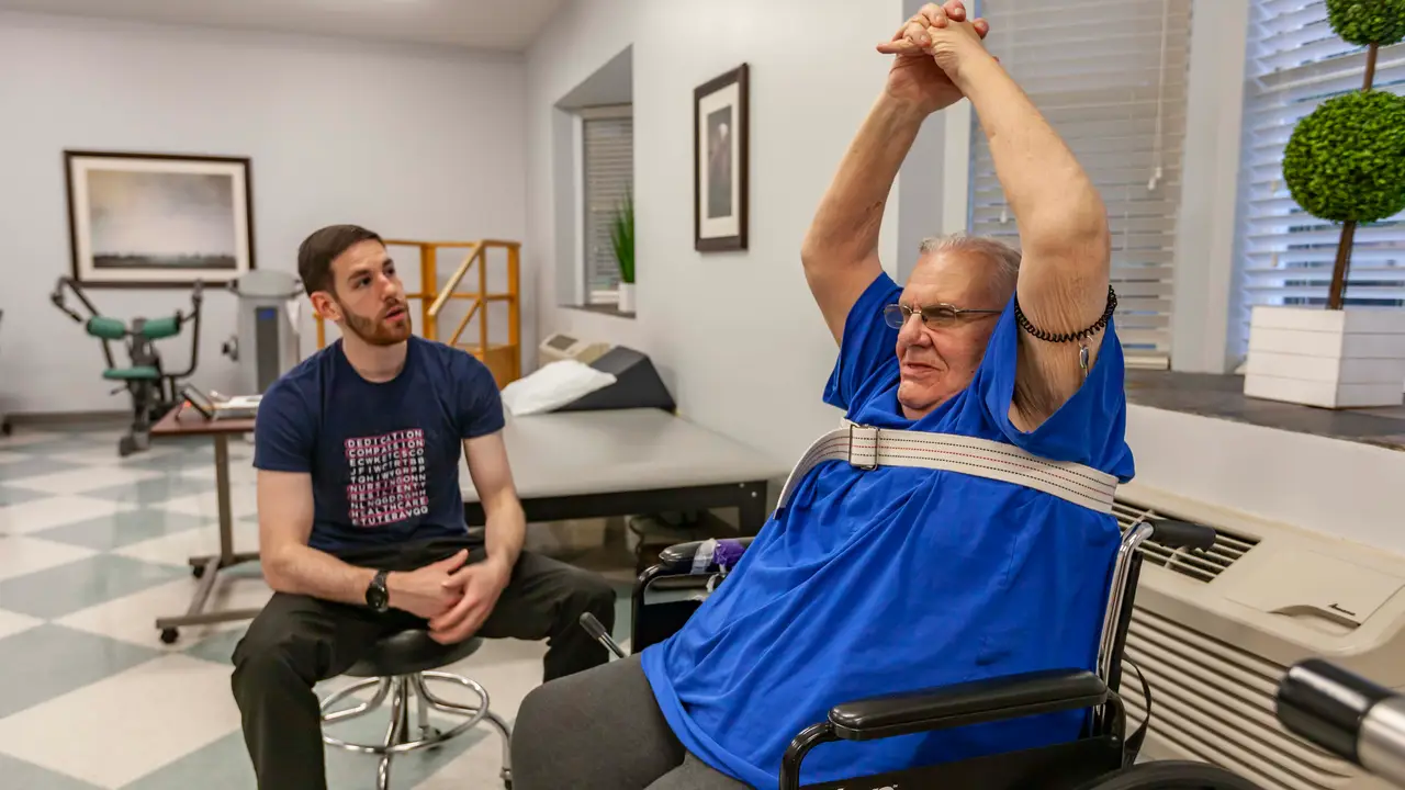 Therapist helping patient do exercises