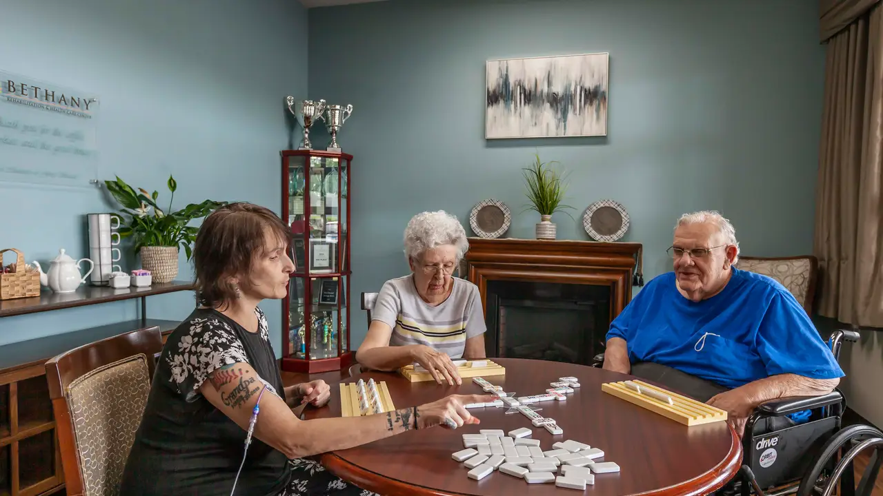 Residents playing dominos in game room