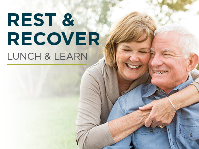 An older woman joyfully hugs an older man from behind outdoors. They both smile warmly. Text on the image reads 