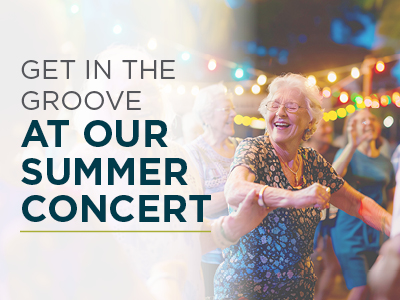 A group of smiling older adults dance joyfully outdoors under string lights at Charlestown Senior Living Community, with text reading 