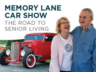 Smiling senior couple stands together in front of a shiny red vintage car. Text reads “Memory Lane Car Show: The Road to Senior Living.”.