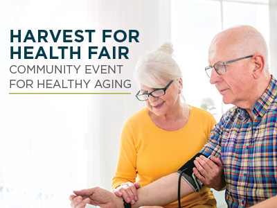 An older woman helps an older man check his blood pressure at a health fair. Text on the image reads: 