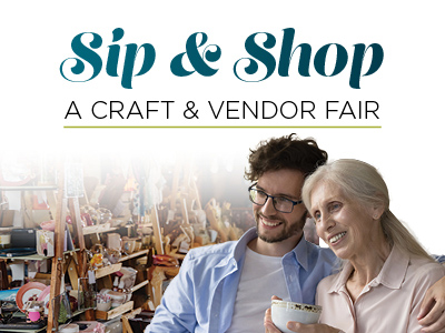 A smiling older woman holding a cup sits beside a younger man at a craft fair, with shelves of handmade items behind them. Text above reads,