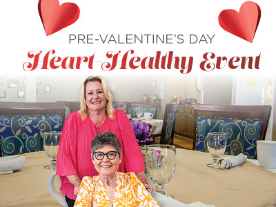 Two women smile in a decorated dining area with tables set for an event. Text above reads,