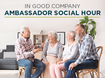 Four smiling older adults sit together in a bright living room, engaged in friendly conversation, with the text 