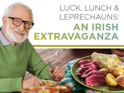 Smiling elderly man eating at a table with a plate of corned beef, cabbage, and potatoes at Charlestown Senior Living Community. Text reads: