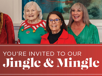 Three smiling older women in festive holiday clothing stand together above a banner that reads,