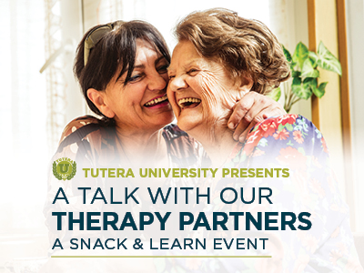Two older women smiling and embracing each other in a bright room. Text reads: “Tutera University Presents: A Talk with our Therapy Partners – A Snack & Learn Event on Assisted Living & Memory Care.”.