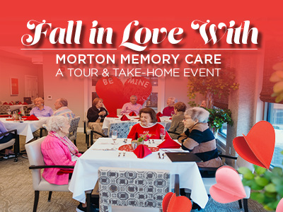 A group of seniors sit at tables decorated for Valentine’s Day in a brightly lit room. The text reads
