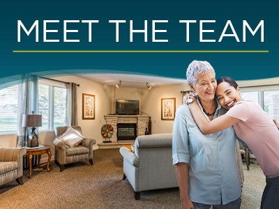 Two women, one older and one younger, smile and hug each other in a cozy, well-lit living room. Above them, bold text reads 