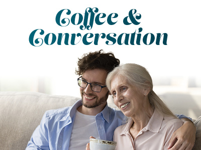 A smiling elderly woman and a young man sit close together on a couch, enjoying a cup of coffee. The text above them reads,