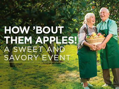 An elderly couple stands in an orchard, smiling and holding a wicker basket full of apples. Both are wearing green aprons. The text on the image reads, 