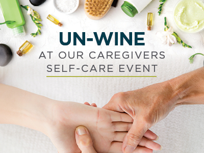 A caregiver massages a person's foot with spa items and essential oils arranged around them in an assisted living setting. Text reads: