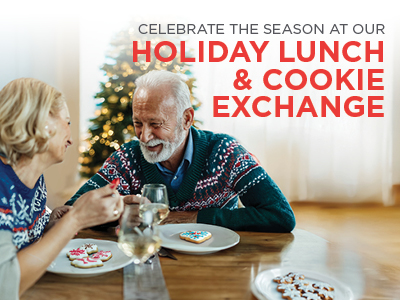 An older couple in festive sweaters enjoys decorated cookies and wine at a holiday lunch. A Christmas tree is visible in the background, and text reads 