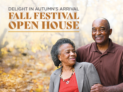An older couple smiles while standing together outdoors in a park with autumn foliage. Text reads: 