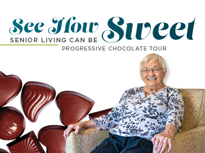 Smiling elderly woman sits in an armchair next to heart-shaped chocolates. Text reads: