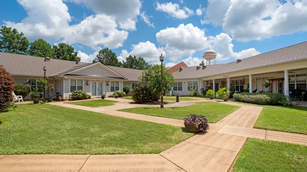 Single-story brick assisted living building with a white portico and columns at The Gables at Charlton Place in Deatsville, AL, Elmore County.