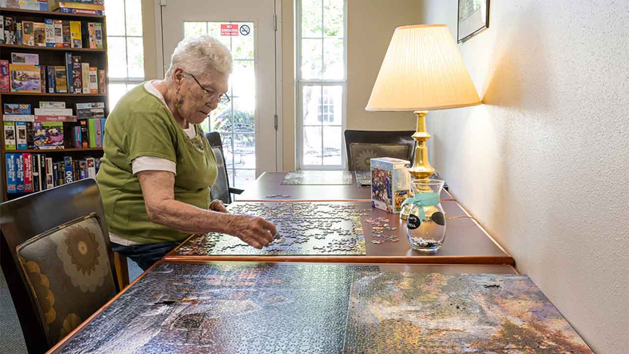 Resident putting together a puzzle at Eiler Senior Living
