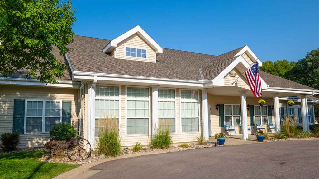 Residential-style assisted living building with a spacious back patio at Floyd Senior Living in Sergeant Bluff, IA, Woodbury County.