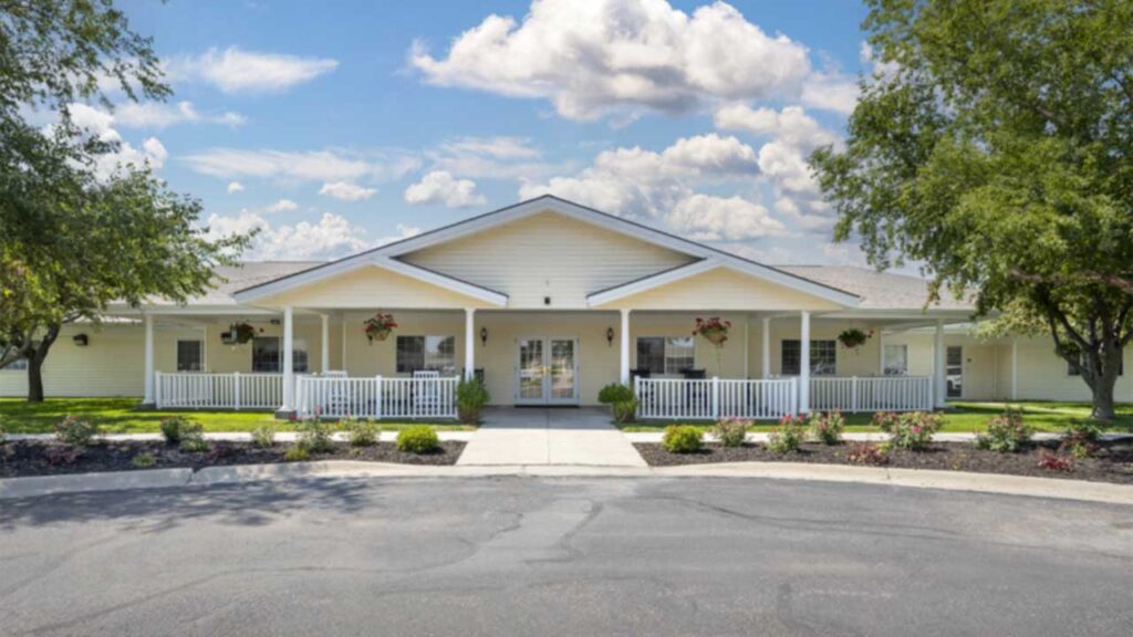 Single-story assisted living building with a white porch and railings at Greene Senior Living in Seward, NE, Seward County.