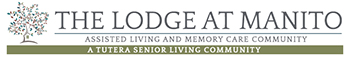 Logo for The Lodge at Manito, an Assisted Living & Memory Care community, featuring a stylized tree graphic on the left and the text “A Tutera Senior Living Community” below.