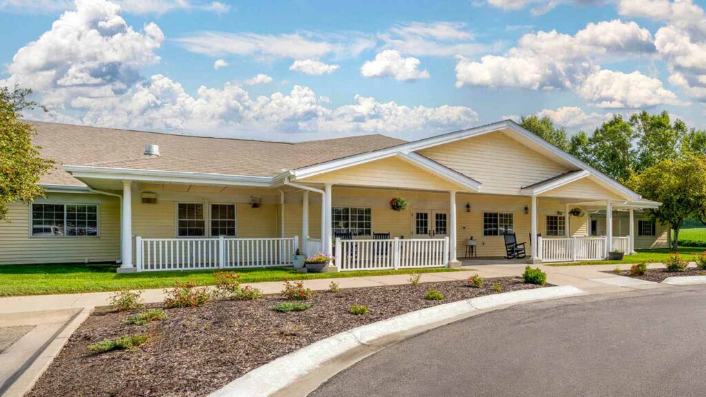 Modern single-story beige building with a white porch at Morton Memory Care in Nebraska City, NE, Otoe County.