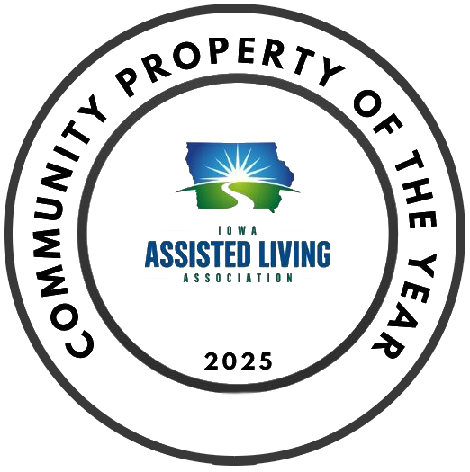 A circular badge with "Community Property of the Year" around the edge, the Iowa Assisted Living Association logo in the center, and "2025" at the bottom.