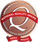 Bronze quality award badge from the National Center for Assisted Living, featuring a prominent "Q" in the center. Text around the badge reads: "Program Flash Care & Support," "National Quality Award," "National Center for Assisted Living Rehabilitation & Health Care Center," and "2024 Bronze.