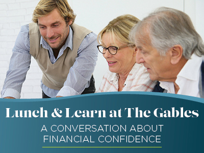 Three adults, two men and one woman, sit together talking and smiling in an assisted living community. Text overlay reads: "Lunch & Learn at The Gables. A Conversation About Financial Confidence.