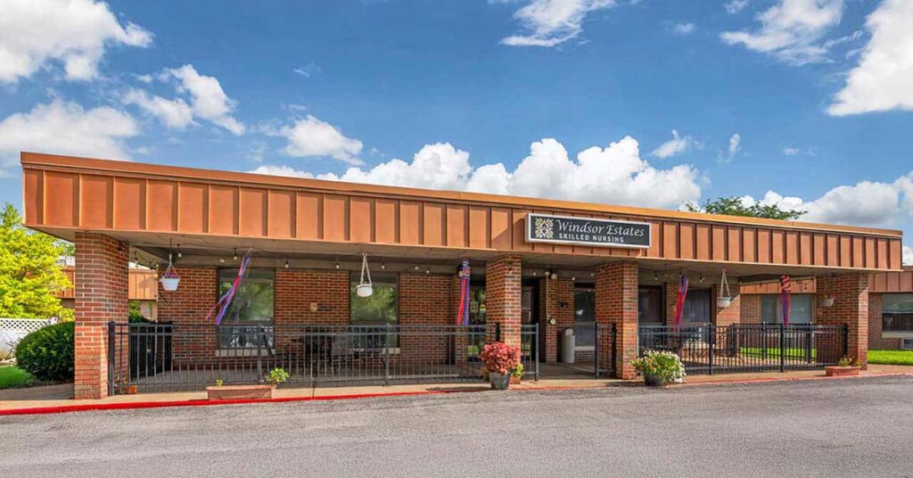 A single-story brick building with a covered entrance, labeled 