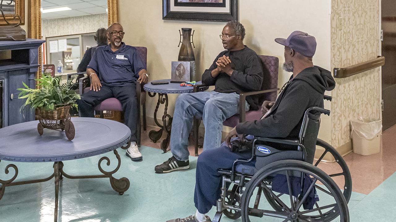 Highland senior male residents visiting in common area