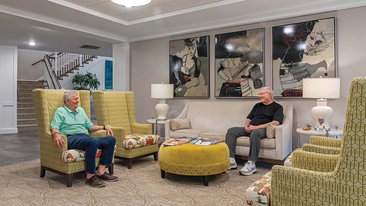 Mission Chateau senior male residents talking in common area