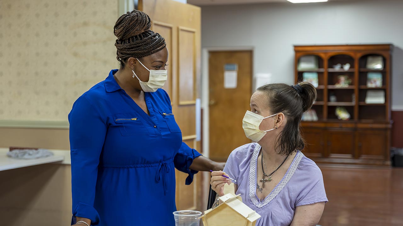 Meridian nurse talking to a patient in lab