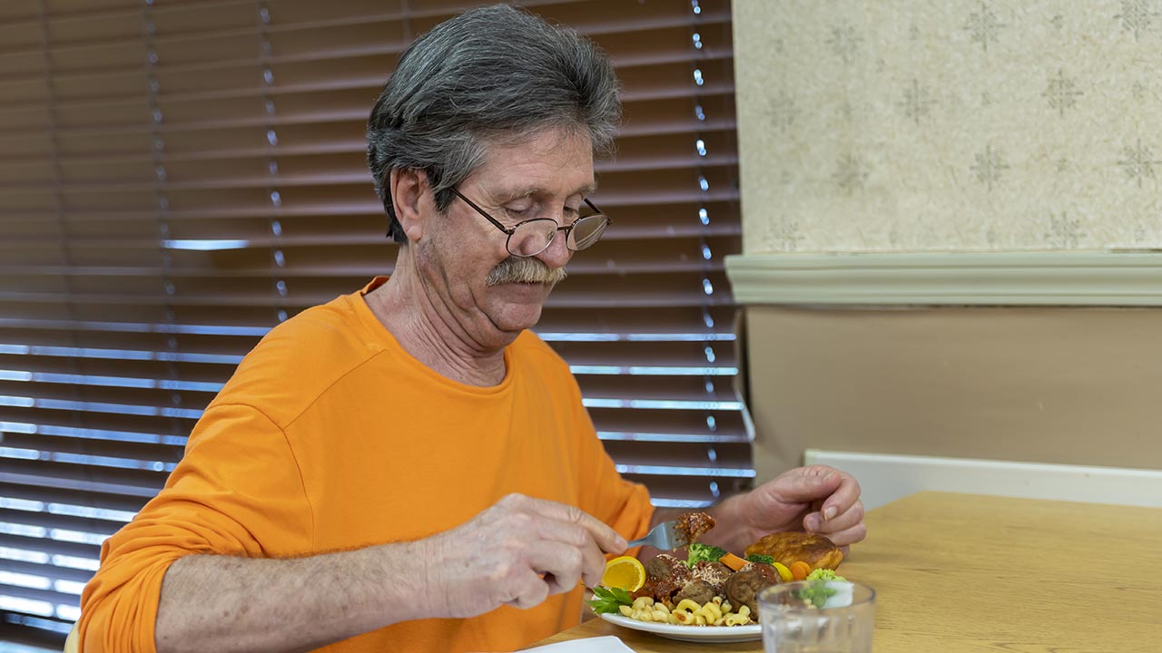 Meridian resident eating lunch in dining room