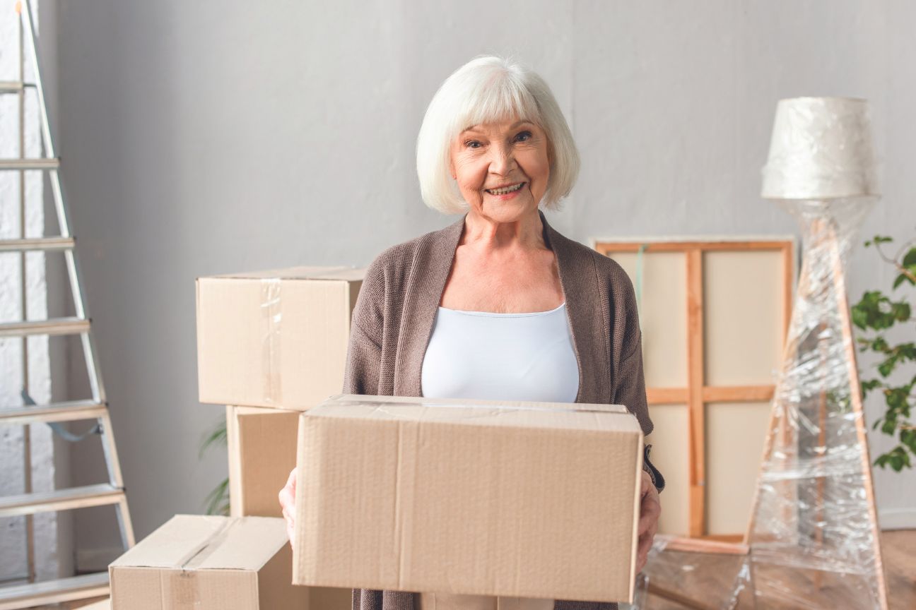 Senior female packing household items to move