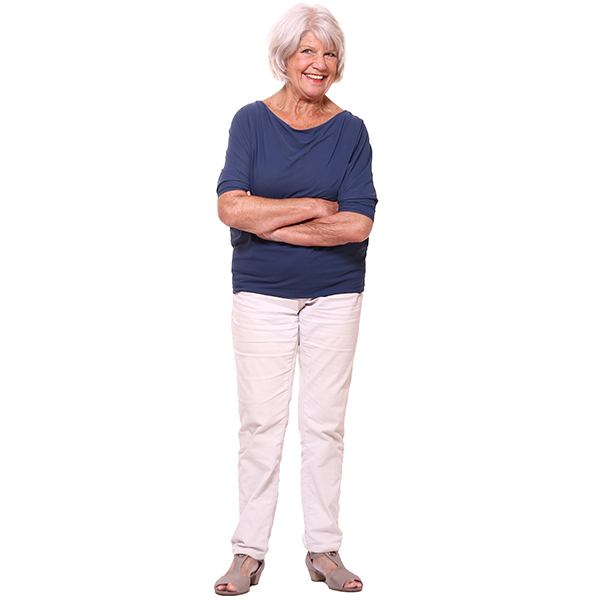 Senior woman standing, smiling with her arms crossed