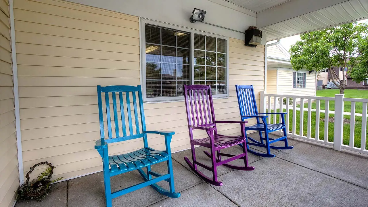 Cottonwood Senior Living covered porch with rocking chairs
