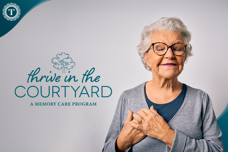 Elderly woman with short white hair, wearing glasses and a gray sweater, smiles gently with hands over her chest. Text reads "Thrive in the Courtyard: A Memory Care Program" with a tree logo symbolizing tranquility and care.