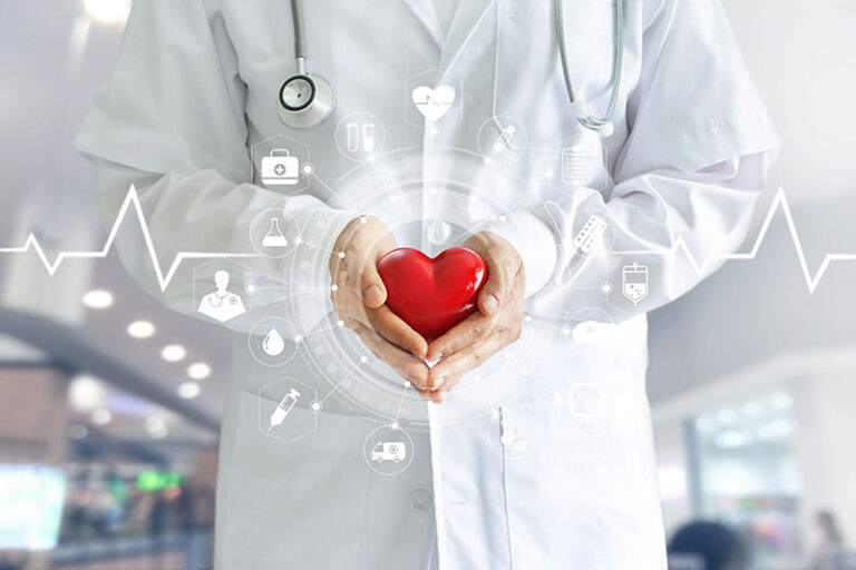 Person in white coat holding red heart with health related graphic overlay