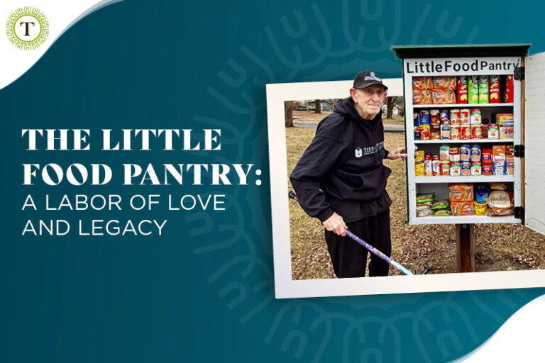 Man standing next to a stocked Little Food Pantry, holding a cane.